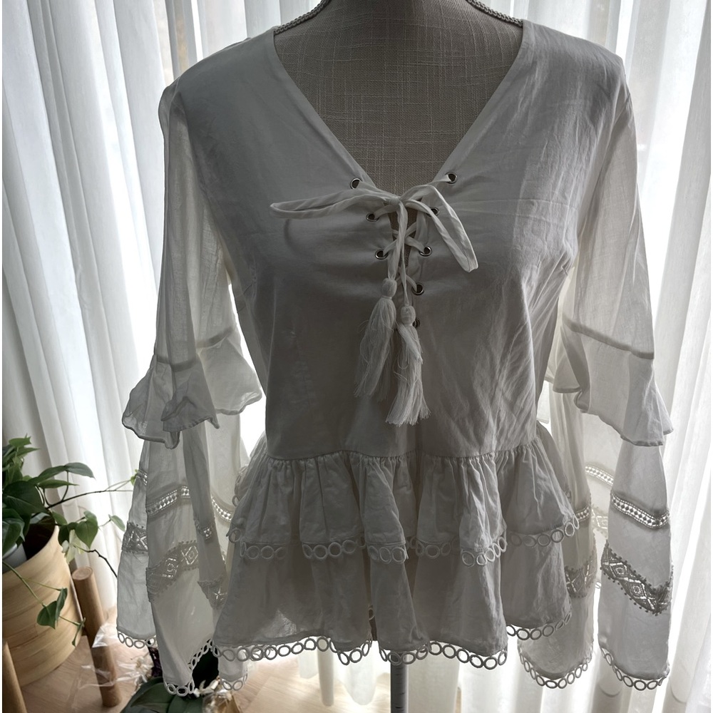 2 beautiful shirts. White shirt with bell sleeves the buckle shirt size small
